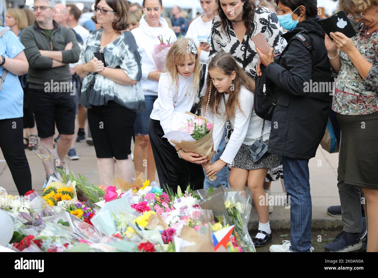 London, UK. 10th Sep, 2022. Two schoolgirls place flowers as part of a sea of floral tributes for Her Majesty Queen Elizabeth II. Credit: Simon Ward/Alamy Live News Stock Photo