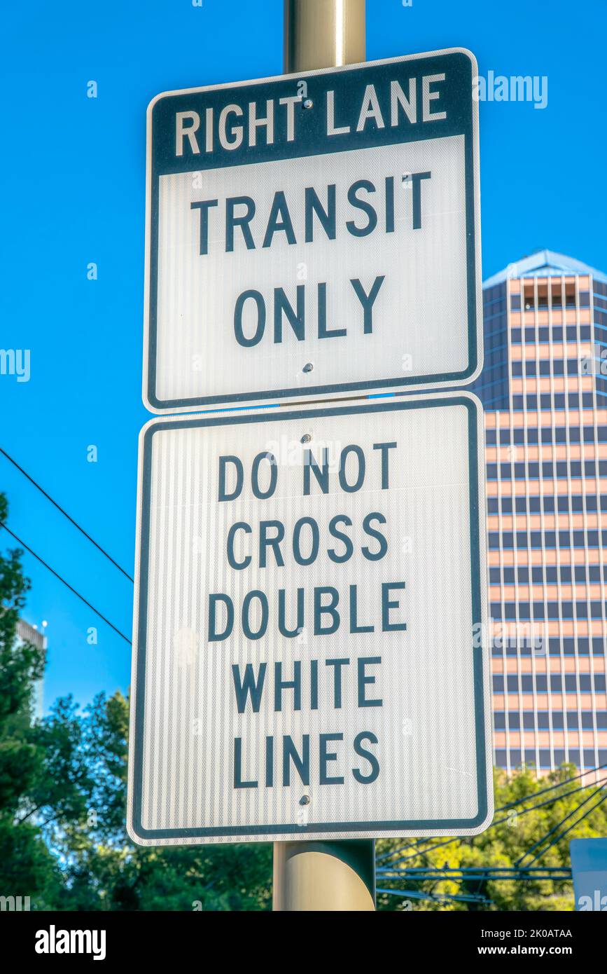 Right lane transit only and do not cross double white lines road signs