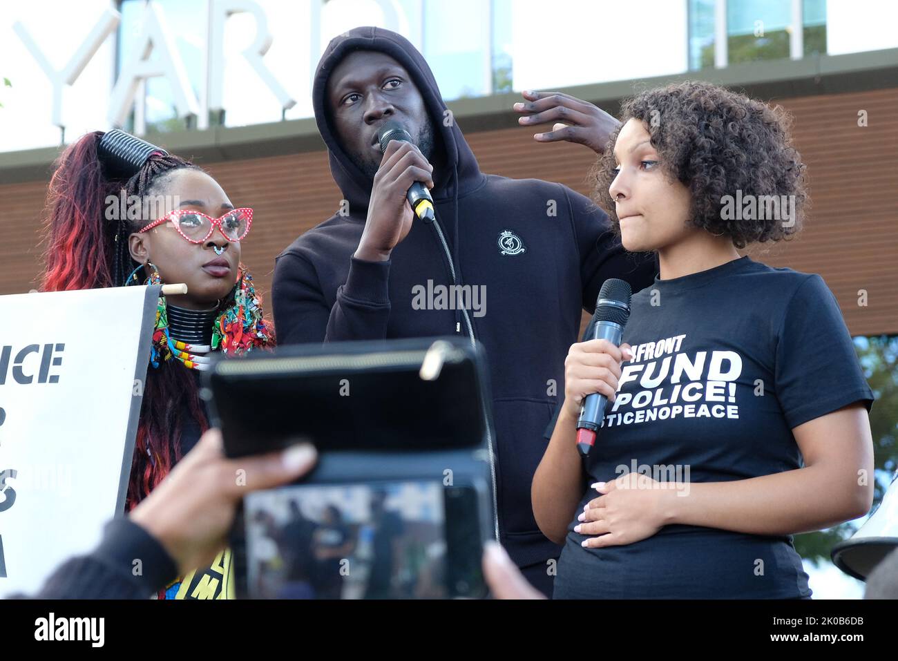 London, UK. 10th September, 2022. Singer Stormzy addresses hundreds of Black Lives Matters protesters outside New Scotland Yard. The demonstrators marched from Parliament Square to the police HQ calling for justice following a fatal shooting of father-to-be Chris Kaba, an unarmed black man, last Monday in sout London by police.  The IOPC are treating the investigation as homicide. Credit: Eleventh Hour Photography/Alamy Live News Stock Photo