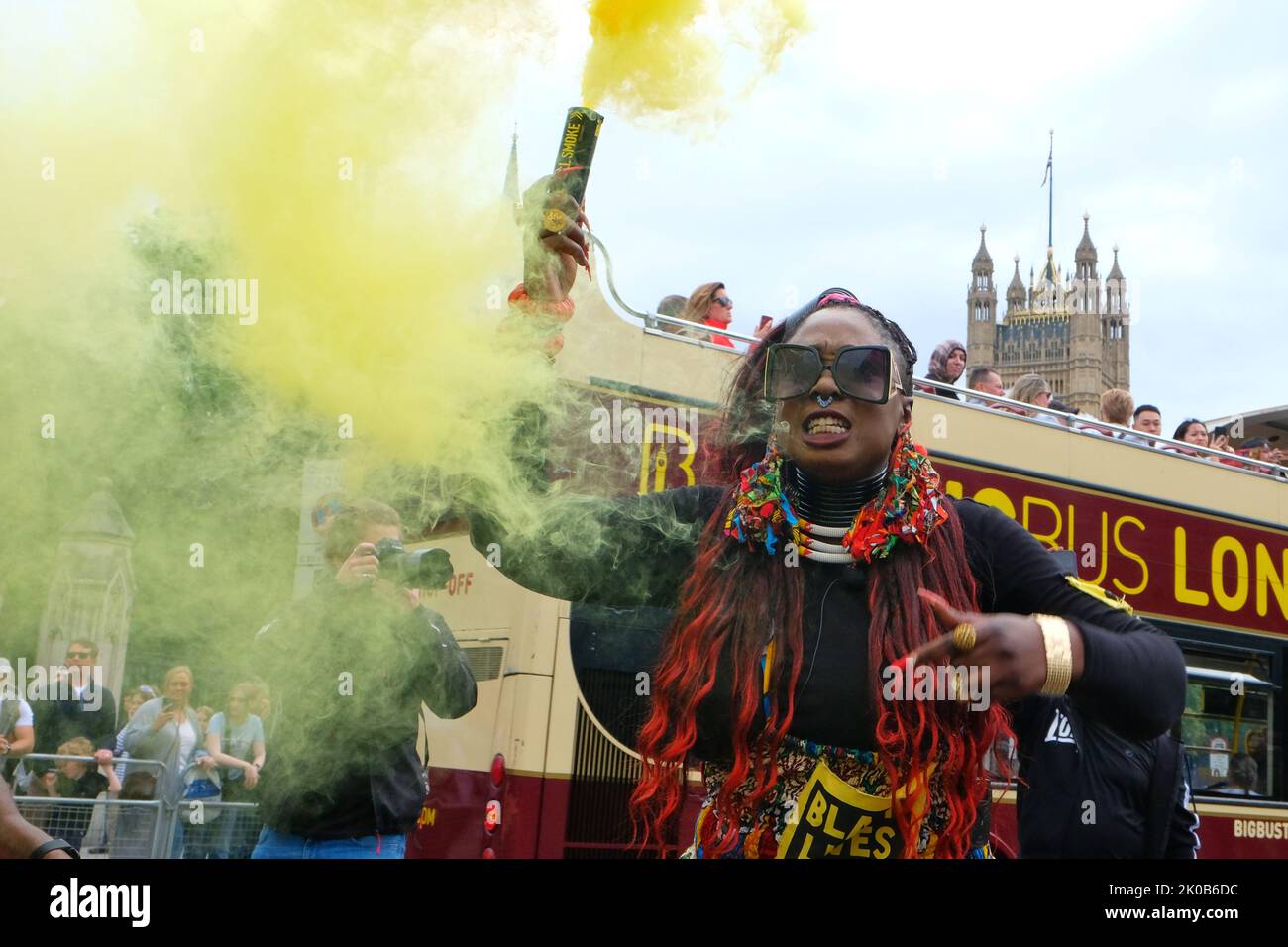 London, UK. 10th September, 2022. Activist Marvina Newton holds a yellow smoke grenade as she walks with hundreds of Black Lives Matters protesters marching from Parliament Square to New Scotland Yard following a fatal shooting of father-to-be Chris Kaba, an unarmed black man, last Monday in south London by police.  The IOPC are treating the investigation as homicide. Credit: Eleventh Hour Photography/Alamy Live News Stock Photo