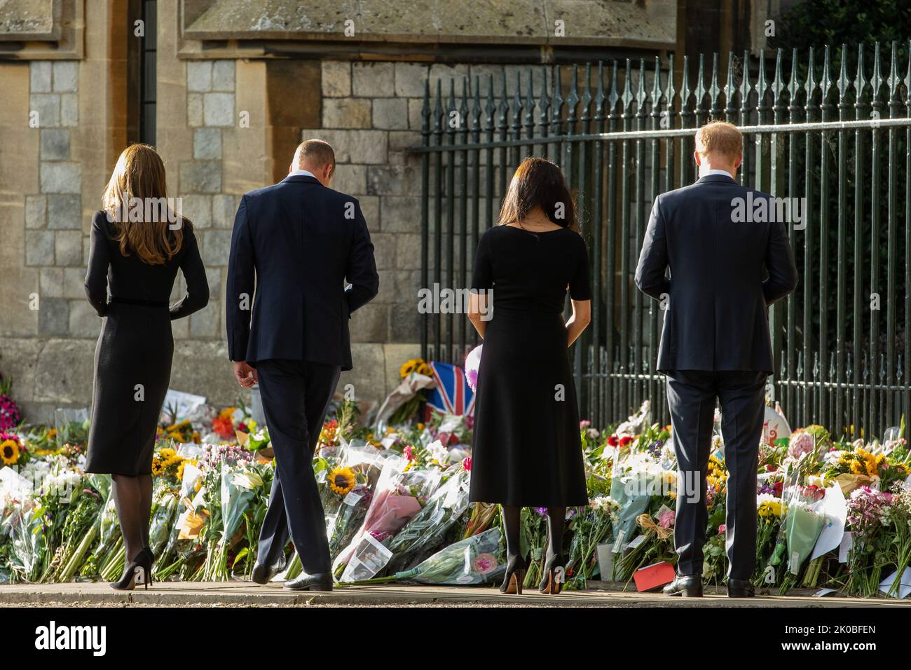 Windsor, UK. 10th September, 2022. Prince William and Catherine, the new Prince and Princess of Wales, accompanied by Prince Harry and Meghan, the Duke and Duchess of Sussex, view floral tributes laid outside Cambridge Gate at Windsor Castle following the death of Queen Elizabeth II. Queen Elizabeth II, the UK's longest-serving monarch, died at Balmoral aged 96 on 8th September 2022 after a reign lasting 70 years. Credit: Mark Kerrison/Alamy Live News Stock Photo