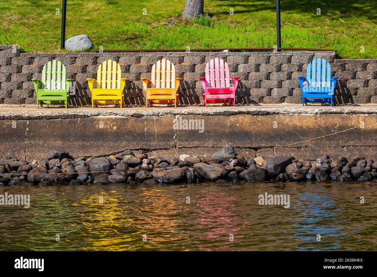 Colorful adirondack chairs above a lake in Wisconsin, horizontal Stock Photo