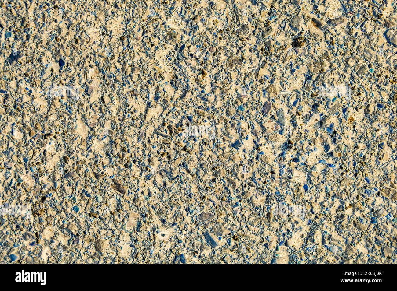 the texture of the old asphalt with a negative effect applied to make it look like a cement-concrete surface, selective focus Stock Photo