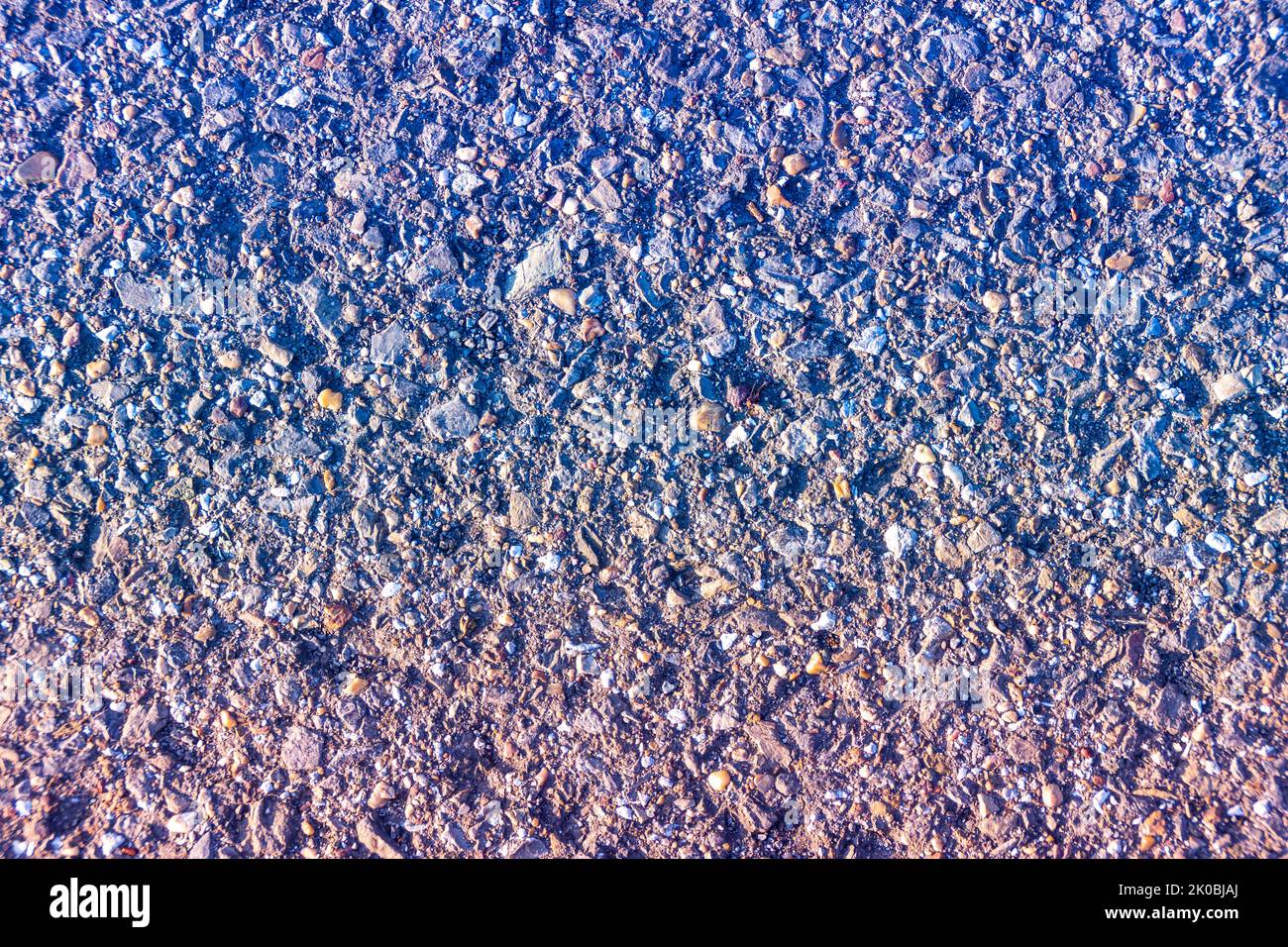 old asphalt with blue-red gradient overlay, selective focus Stock Photo
