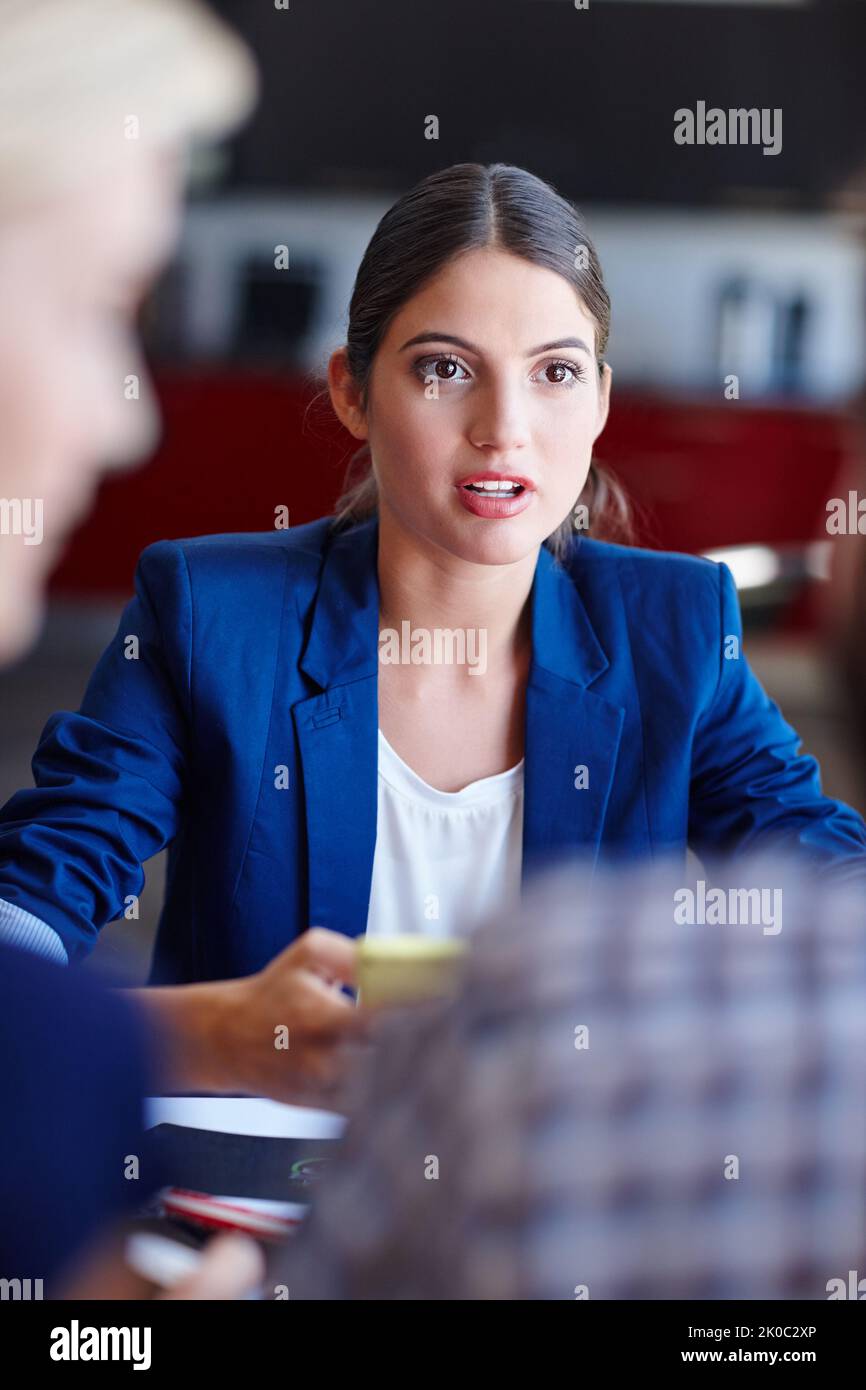 What if...a young creative professional in a meeting with her coworkers. Stock Photo