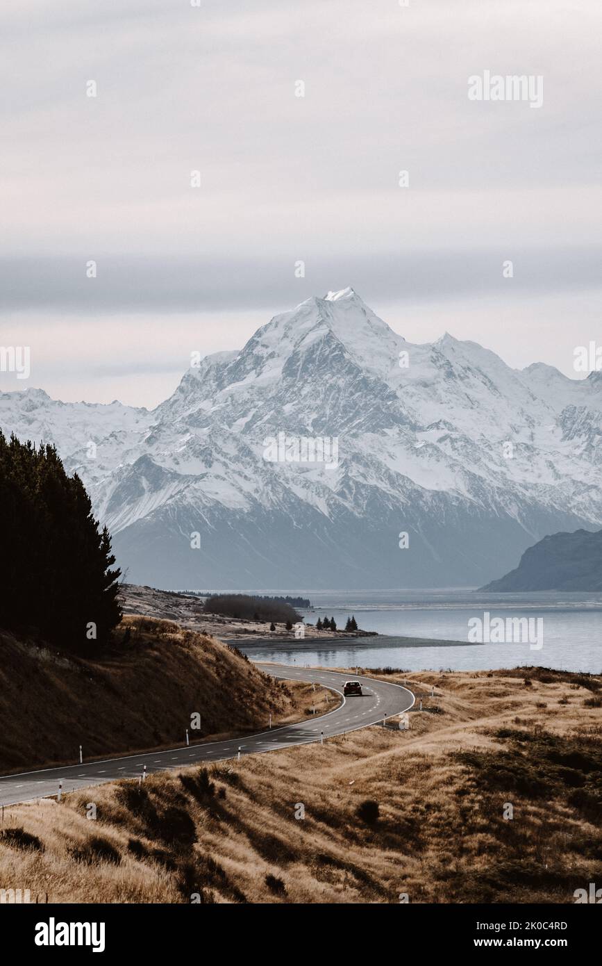 View of the majestic Aoraki Mount Cook with the road leading to Mount Cook Village. Taken during winter in New Zealand. Stock Photo
