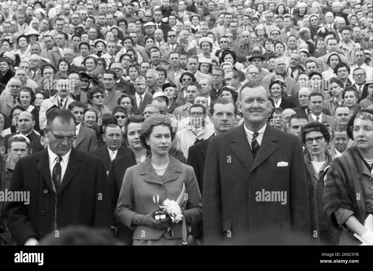 Queen Elizabeth II with Maryland governor Theodore McKeldin (right) and University of Maryland president Wilson Homer 'Bull' Elkins (left), at a Maryland Terrapins vs. the North Carolina Tar Heels football game in College Park, Maryland. (USA) Stock Photo