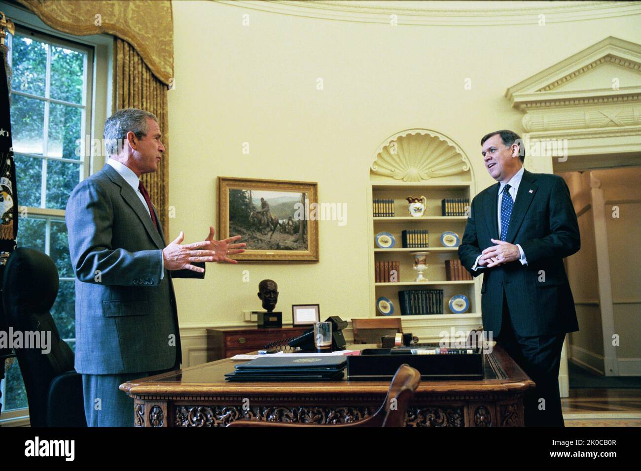 P34435-12.jpg. Secretary Mel Martinez at White House Announcement of Cuba Initiative Subject, Secretary Mel Martinez with President George W. Bush, Secretary of State Colin Powell at White House Rose Garden announcement of the Cuba Initiative--submission to Congress of the Tobacco Patriot and Assistance Act of 2003, providing production and educational training subsidies as well as tax breaks designed to revive American production of cigars to compete with Cuban imports and reduce the profitability of that important economic sector for the Fidel Castro regime. Stock Photo