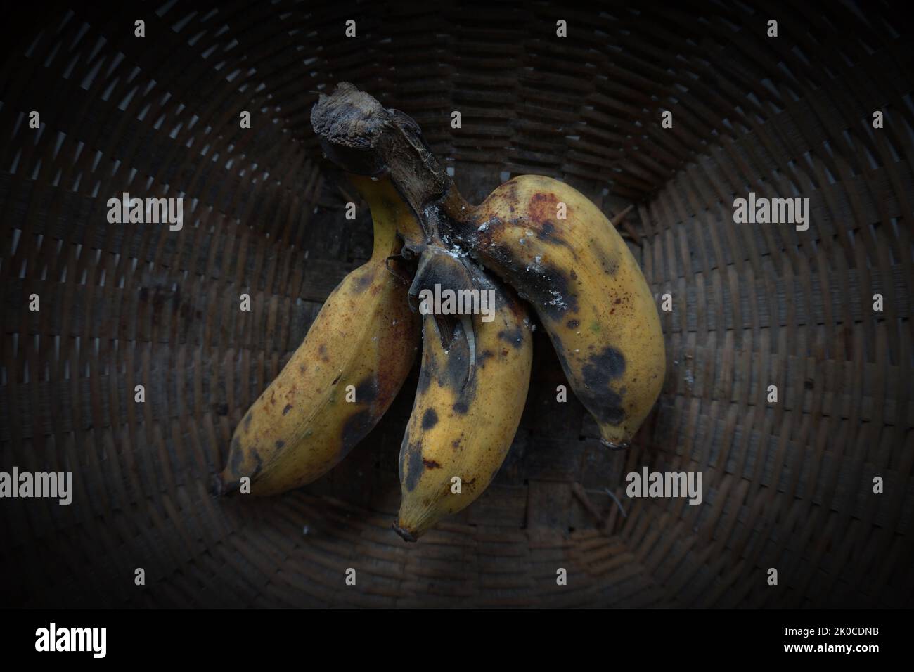 Rotten bananas in an old wicker basket Stock Photo Alamy