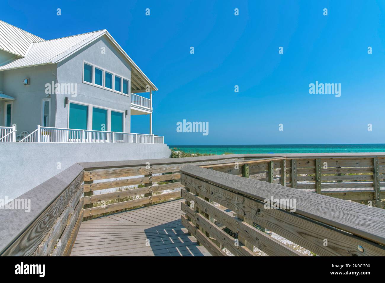 Beach house view from a boardwalk on a beach at Destin, Florida. Wooden boardwalk with a view of