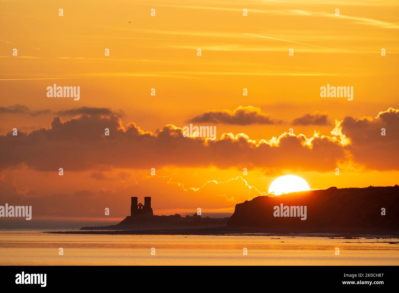 Herne Bay, Kent. 11/09/22. The sunrise over the sea and the landmark Reculver twin towers of the ruined 12th century church, long used as a navigation aid by seafarers. Some ground drifting in over the headland which was quickly dispersed when the sun rose. Credit-Malcolm Fairman, Alamy Live News. Stock Photo