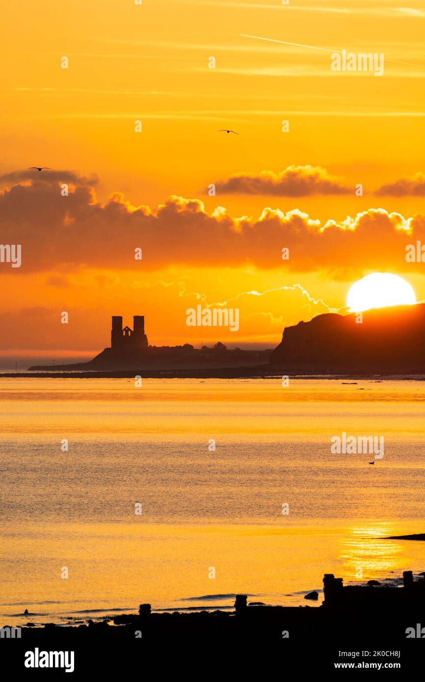 Herne Bay, Kent. 11/09/22. The sunrise over the sea and the landmark Reculver twin towers of the ruined 12th century church, long used as a navigation aid by seafarers. Some ground drifting in over the headland which was quickly dispersed when the sun rose. Credit-Malcolm Fairman, Alamy Live News. Stock Photo