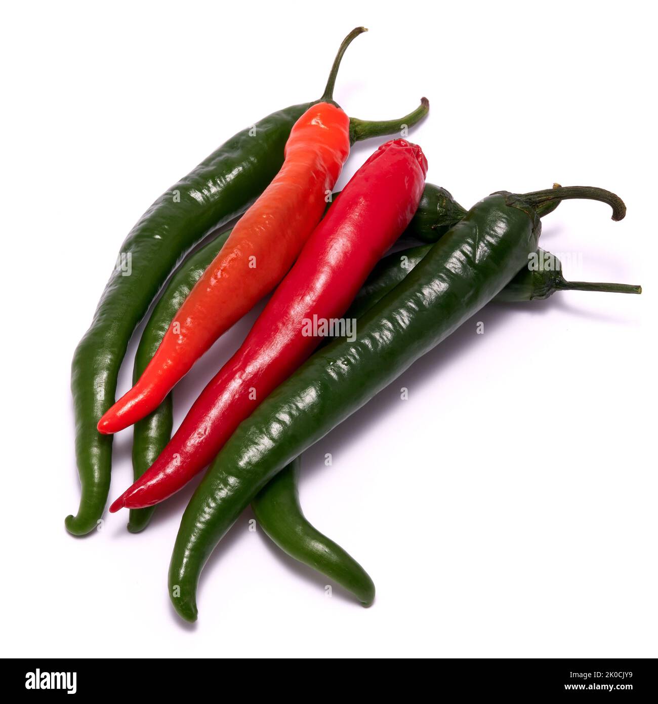 Pile of red and green chili peppers isolated on a white background ...