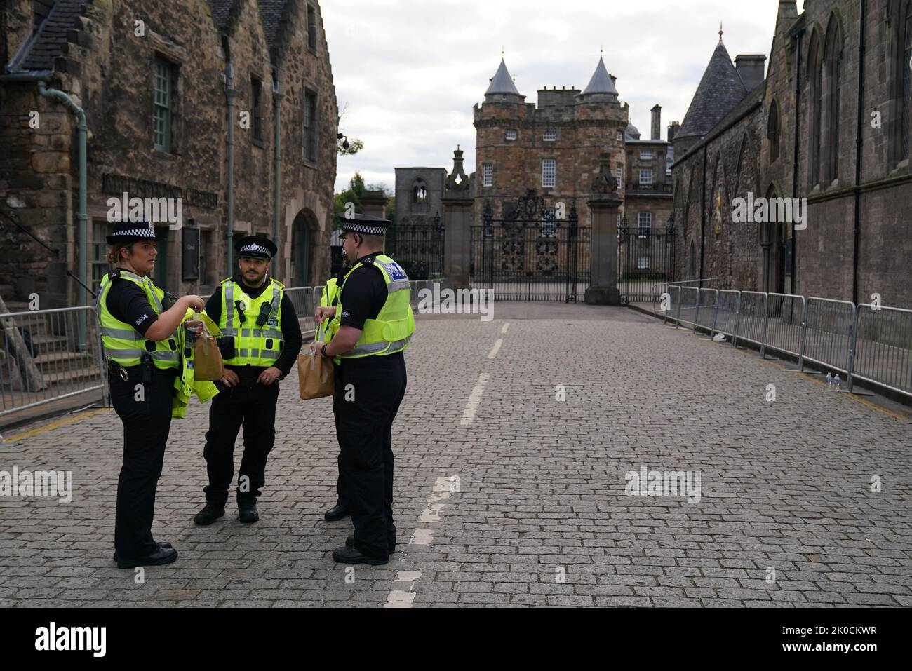 Police officers outside the gates of the Palace of Holyroodhouse in