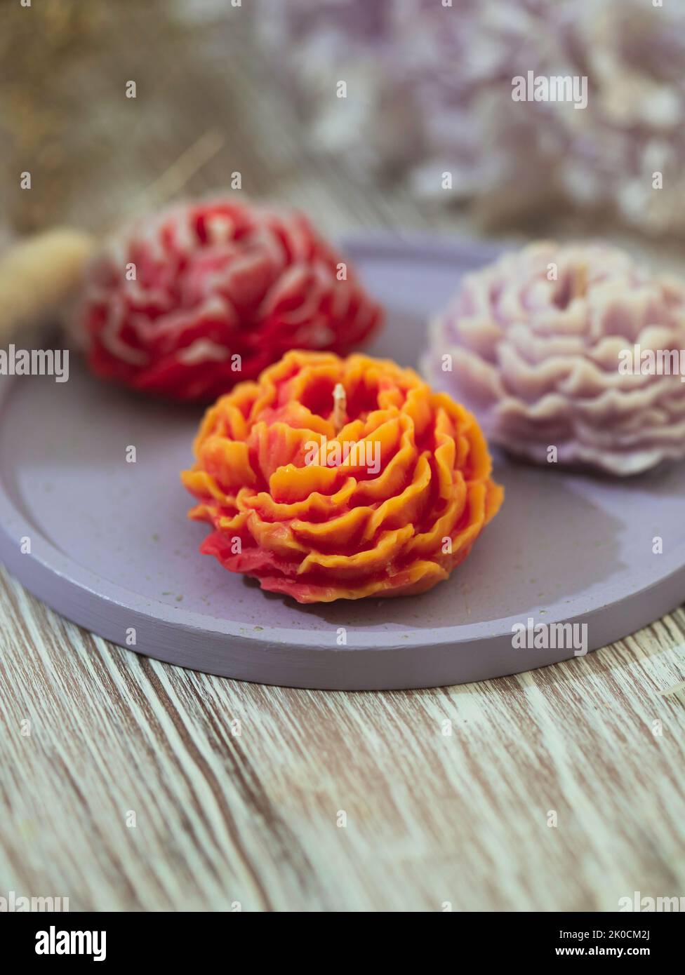 Handmade candles in modern style, beautiful shape. Flower candle. Home decor. Selective focus Stock Photo