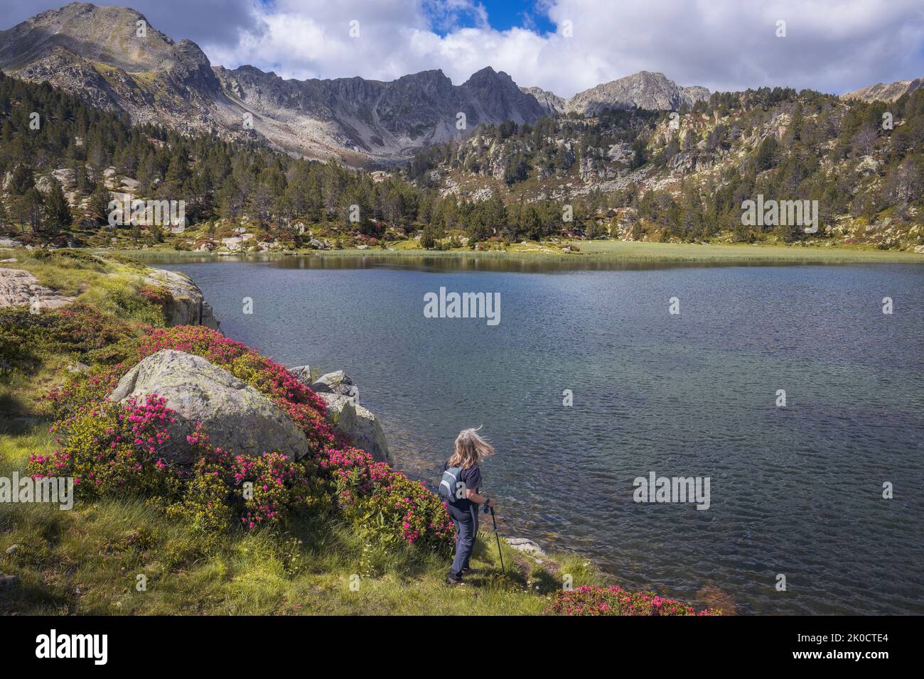 Woman Hiking at Estanys de Pessons in Spring, Andorra Stock Photo