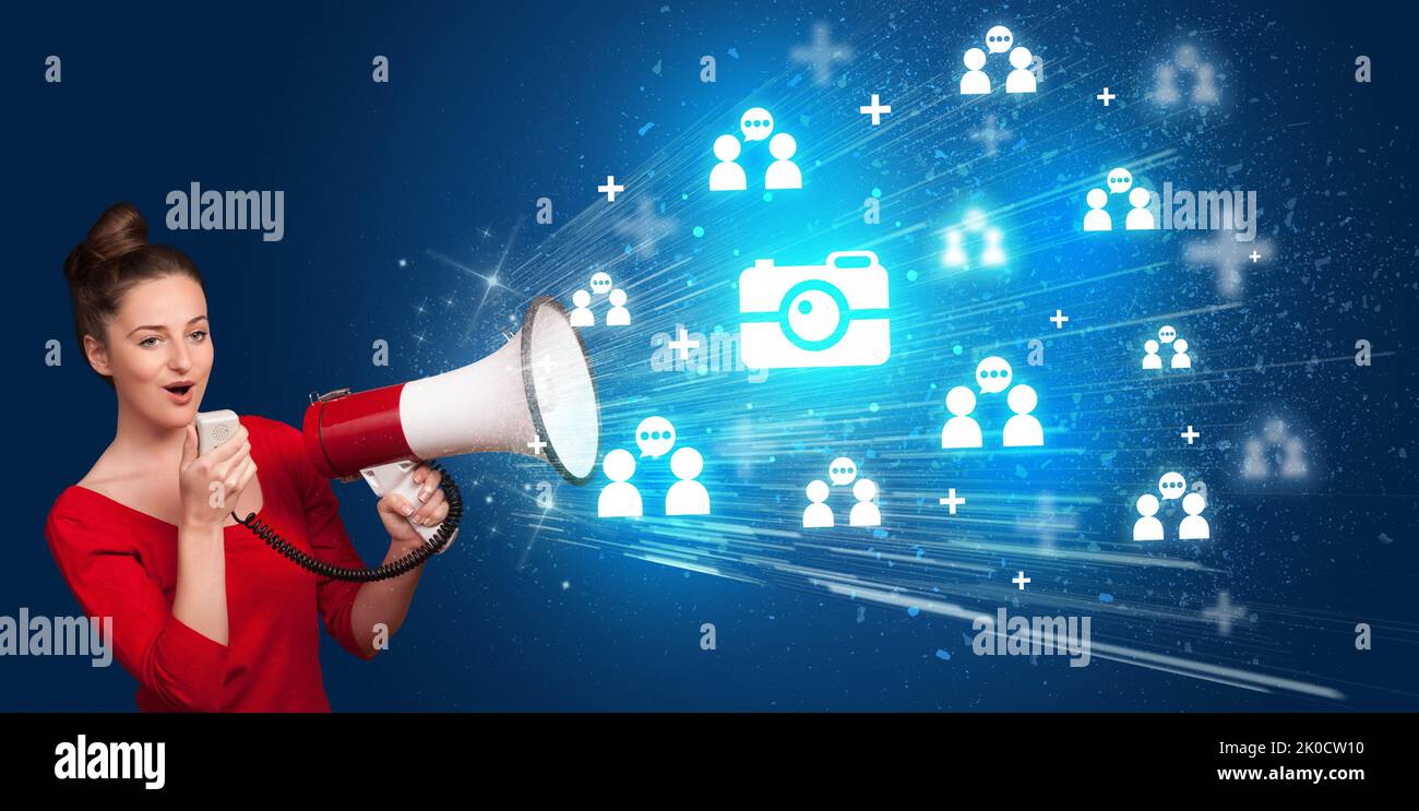 Young person with megaphone and social networking icon Stock Photo