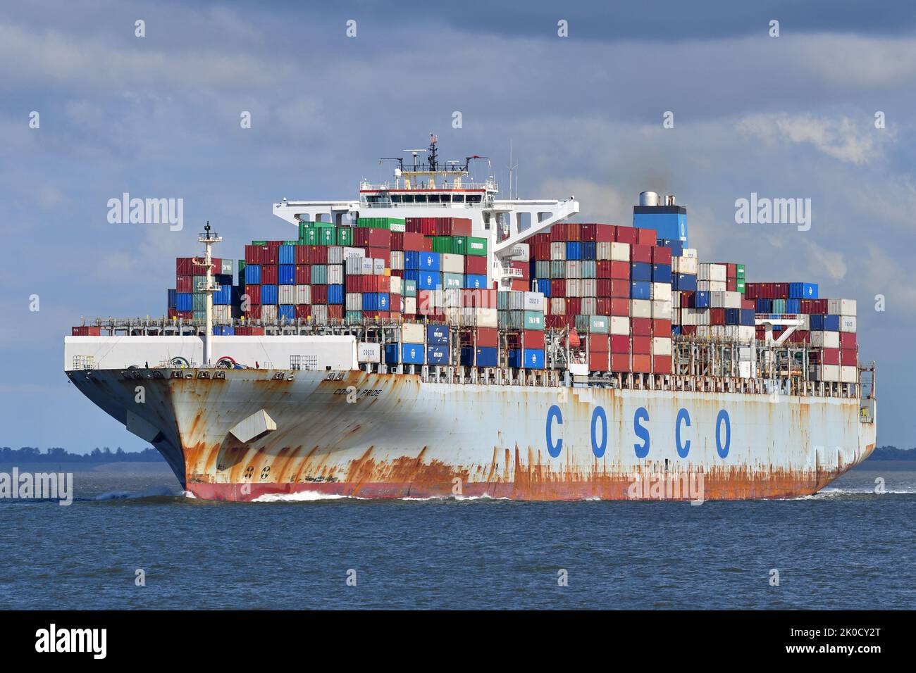 Containership COSCO PRIDE outbound from Hamburg off Cuxhaven Stock Photo
