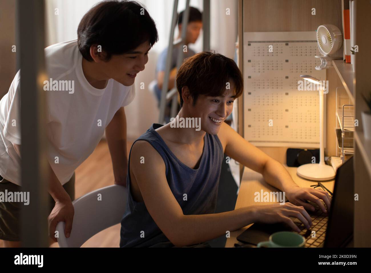 Young Chinese university students using laptop in dormitory Stock Photo