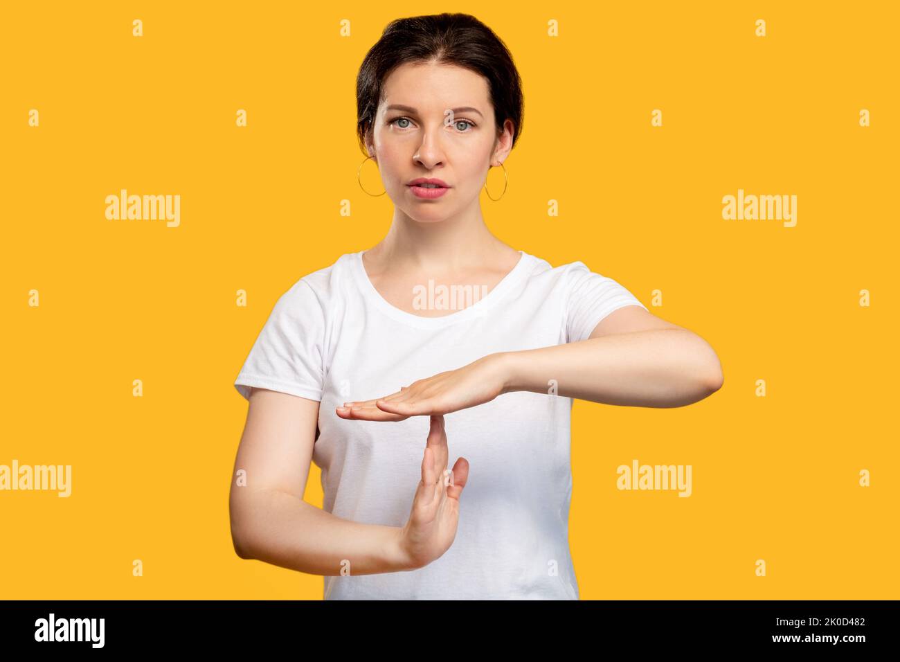 time out gesture need break tired woman on orange Stock Photo