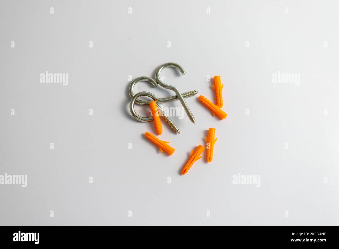 Heap of question mark hooks with plastic plugs on white background Stock Photo