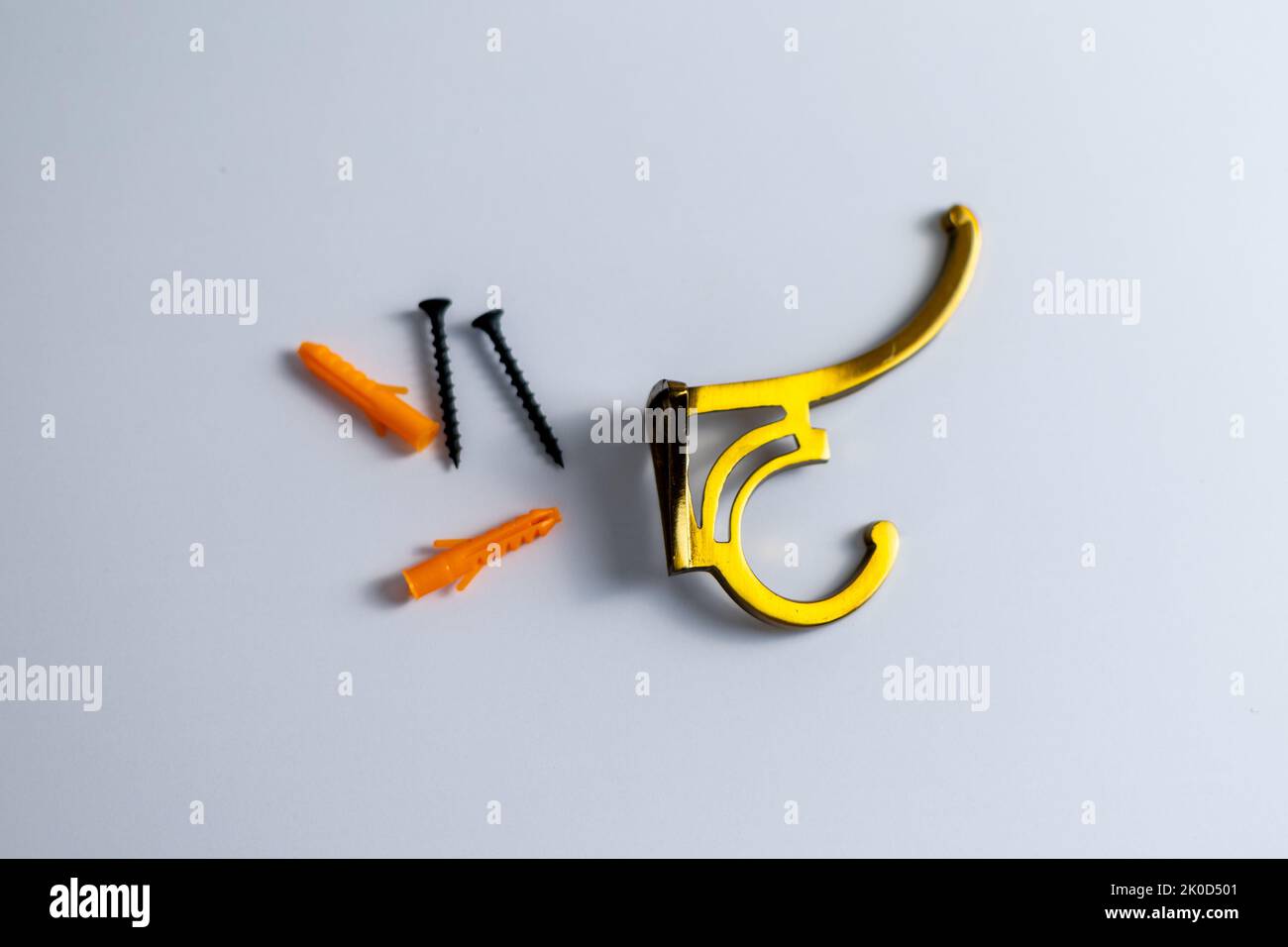 Wall hook hanger with dowels and screws on isolated white background Stock Photo
