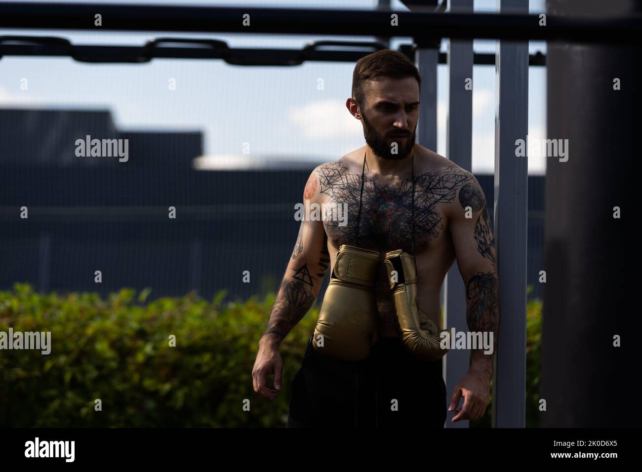 boxer athlete man putting on glove gloves prepared to train outdoors