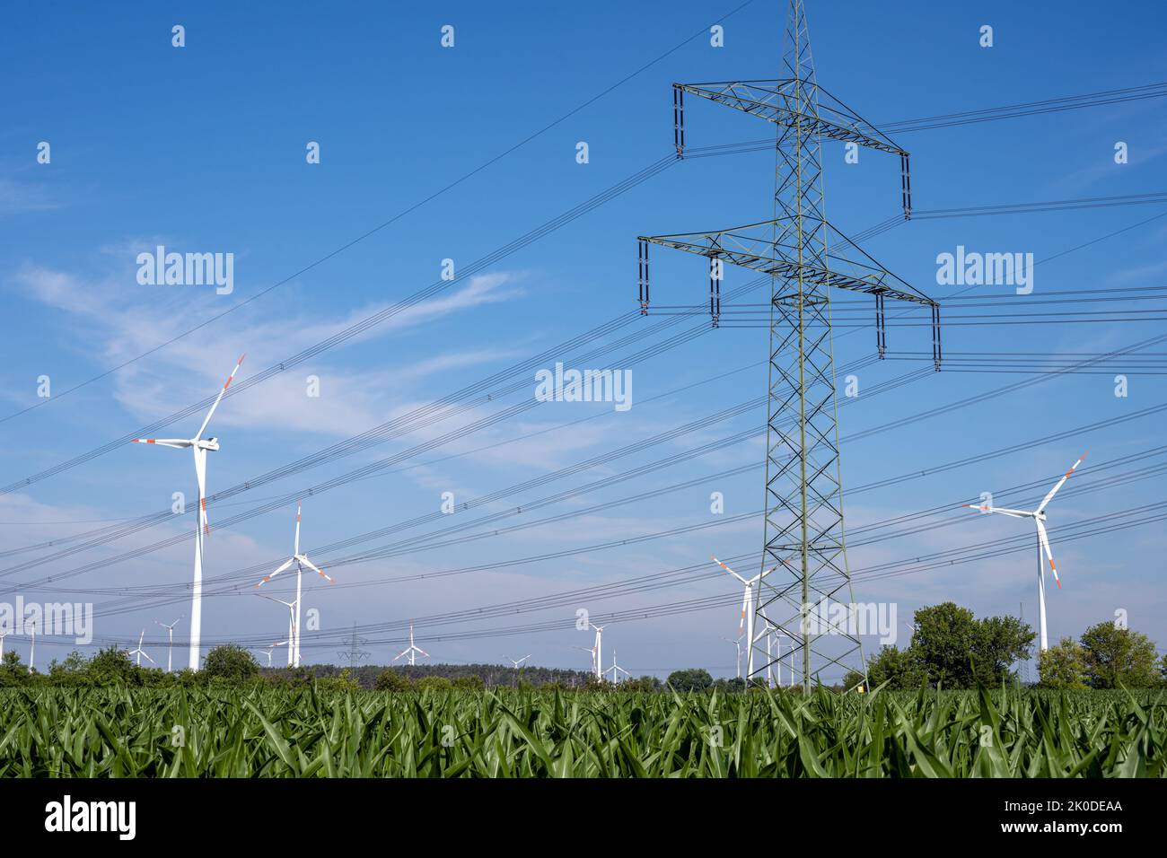 Electricity pylons, power lines and wind turbines seen in Germany Stock Photo