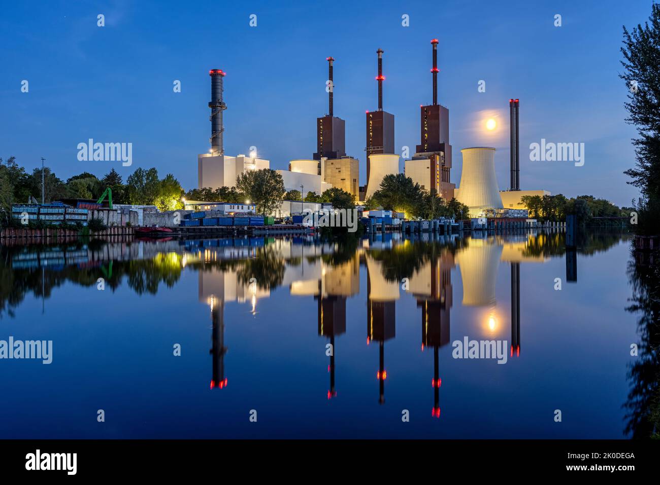 A power station in Berlin at night with a perfect reflection in the water Stock Photo