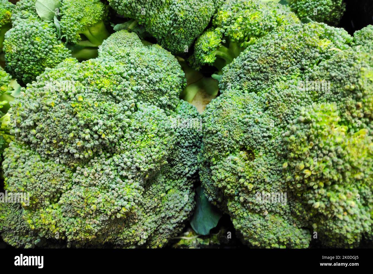 Full frame close-up on a stack of Broccoli on a market stall. Stock Photo