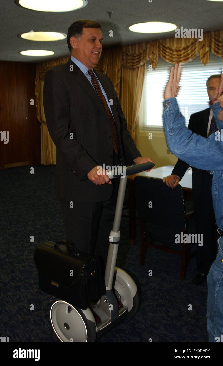 Secretary Mel Martinez, Staff Sampling Personal Transportation Device. Secretary Mel Martinez, Staff Sampling Personal Transportation Device Subject, Secretary Mel Martinez, other senior staff testing the Segway Human Transporter during visit to HUD Headquarters by the Segway's inventor, Dean Kamen. Stock Photo