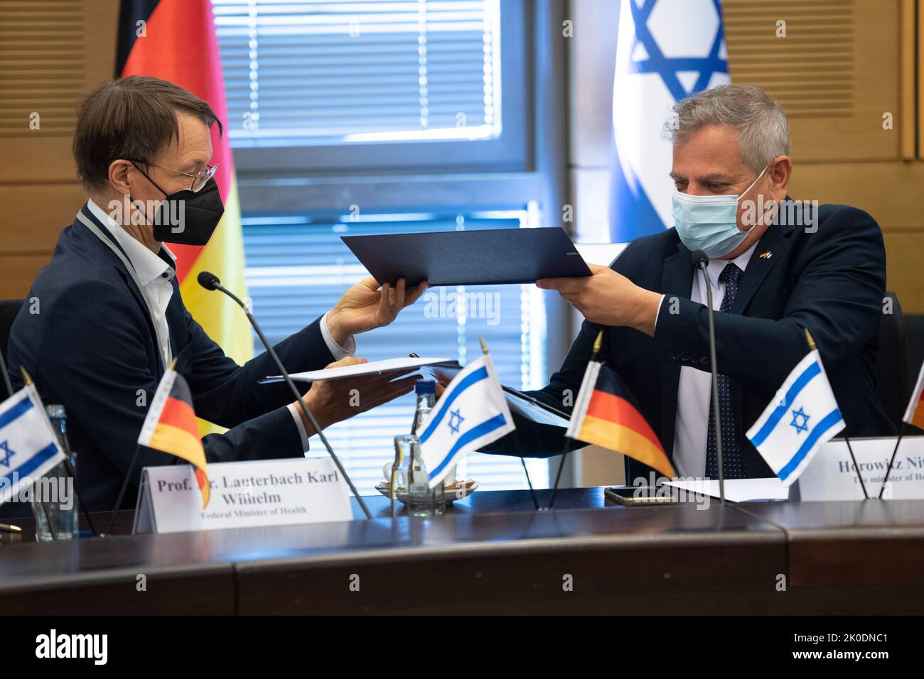 Jerusalem, Israel. 11th Sep, 2022. Karl Lauterbach (SPD, l), Federal Minister of Health, and Nitzan Horowitz, Chairman of the Meretz party and Israeli Minister of Health, sign a joint declaration of intent for cooperation on health policy issues in the Knesset's 'Jerusalem Hall'. For the German minister, the focus in Israel is on German-Israeli friendship, joint pandemic control and Israel as a role model for the digitalization of healthcare. Credit: Christophe Gateau/dpa/Alamy Live News Stock Photo