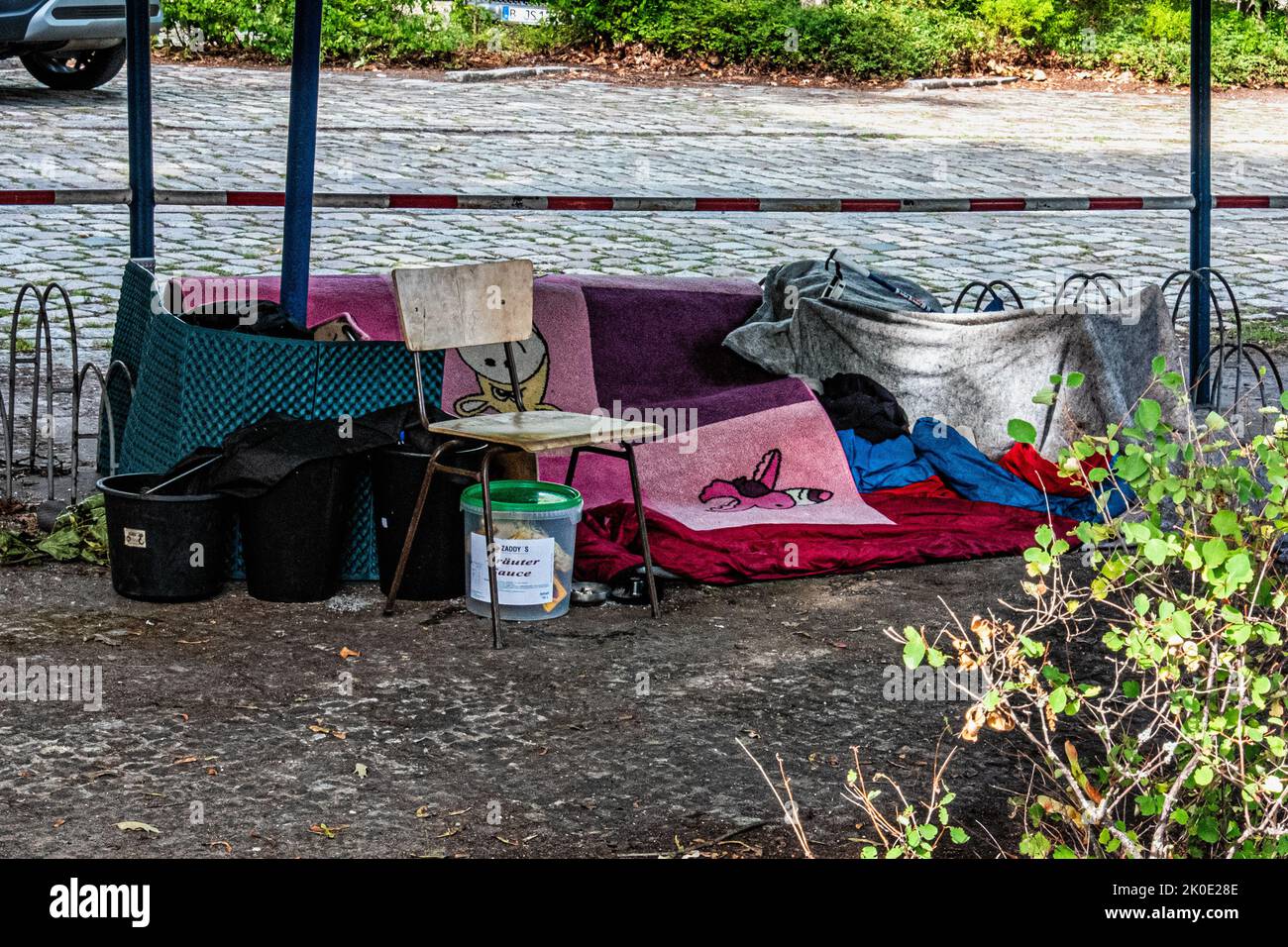 Small encampment and possessions of homeless person in car park , Reinickendorf, Berlin, Germany Stock Photo