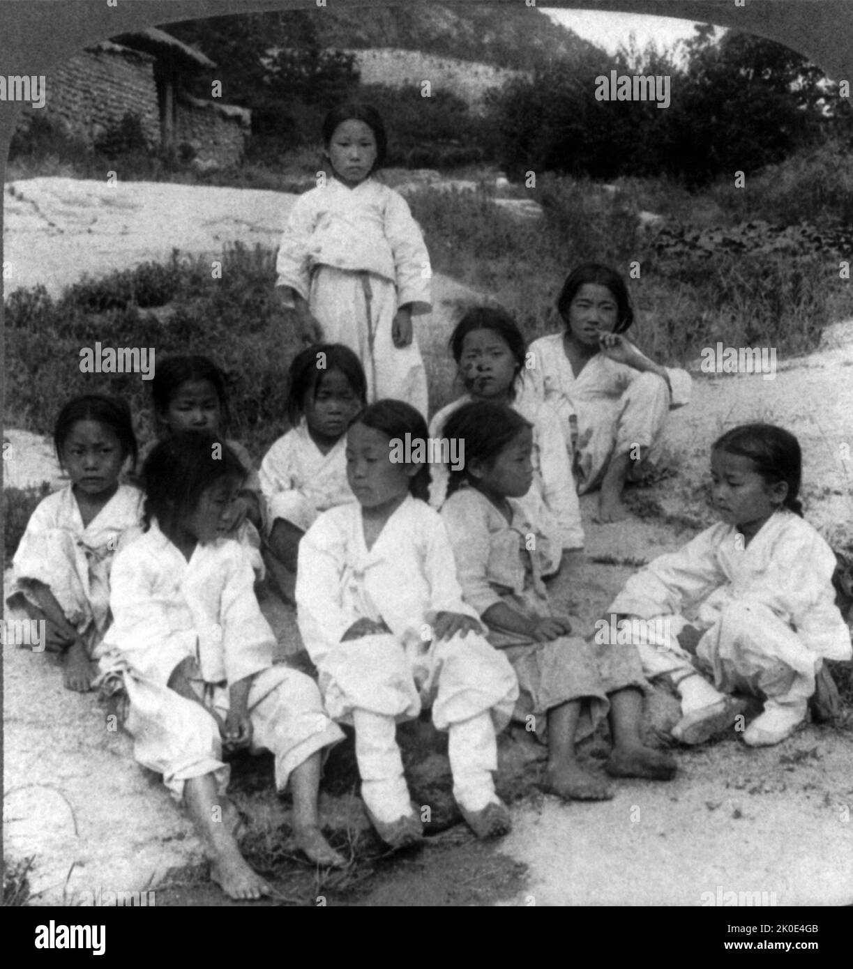 Photograph showing Joseon era boys from a poor area wearing torn clothes. Seoul, Korea 1900. Stock Photo