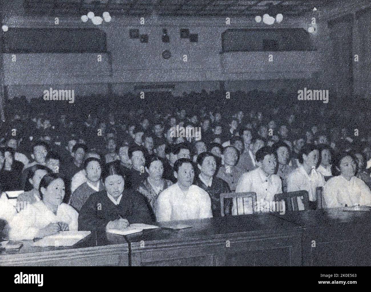 Propaganda photograph of communist party members in North Korea listening to a speech by leader Kim Il-sung as he first introduced the term Chollima in December 1956, shortly before the start of the 1957-61 five-year plan. Stock Photo