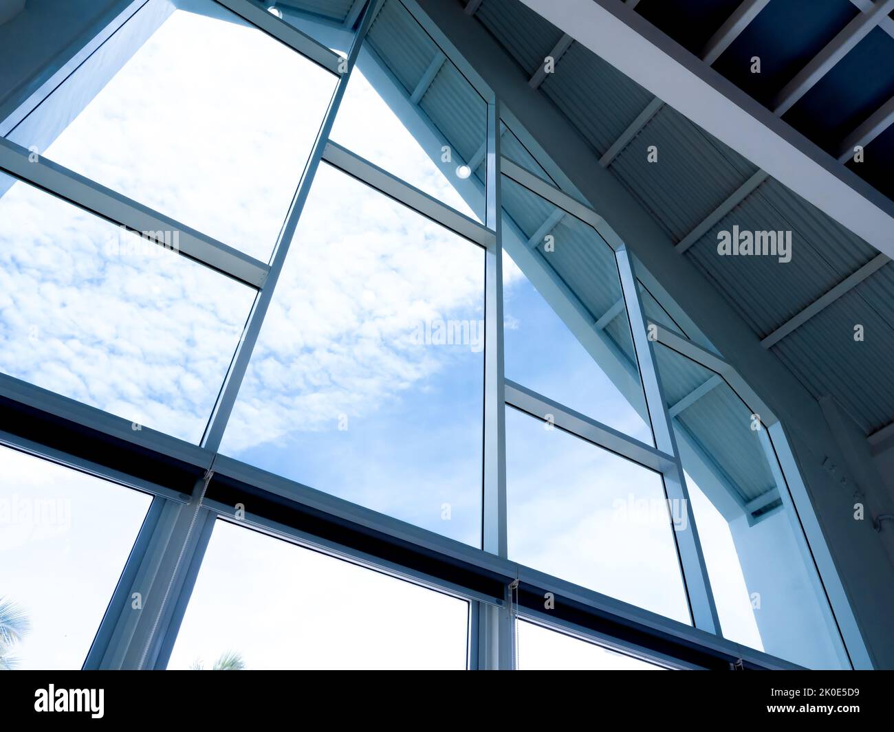 The huge glass window structure on the gabled house. Clear big glass