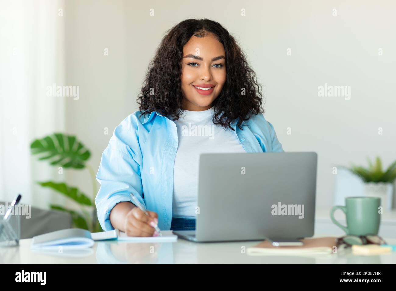 African American Business Lady Using Laptop Taking Notes At Workplace ...
