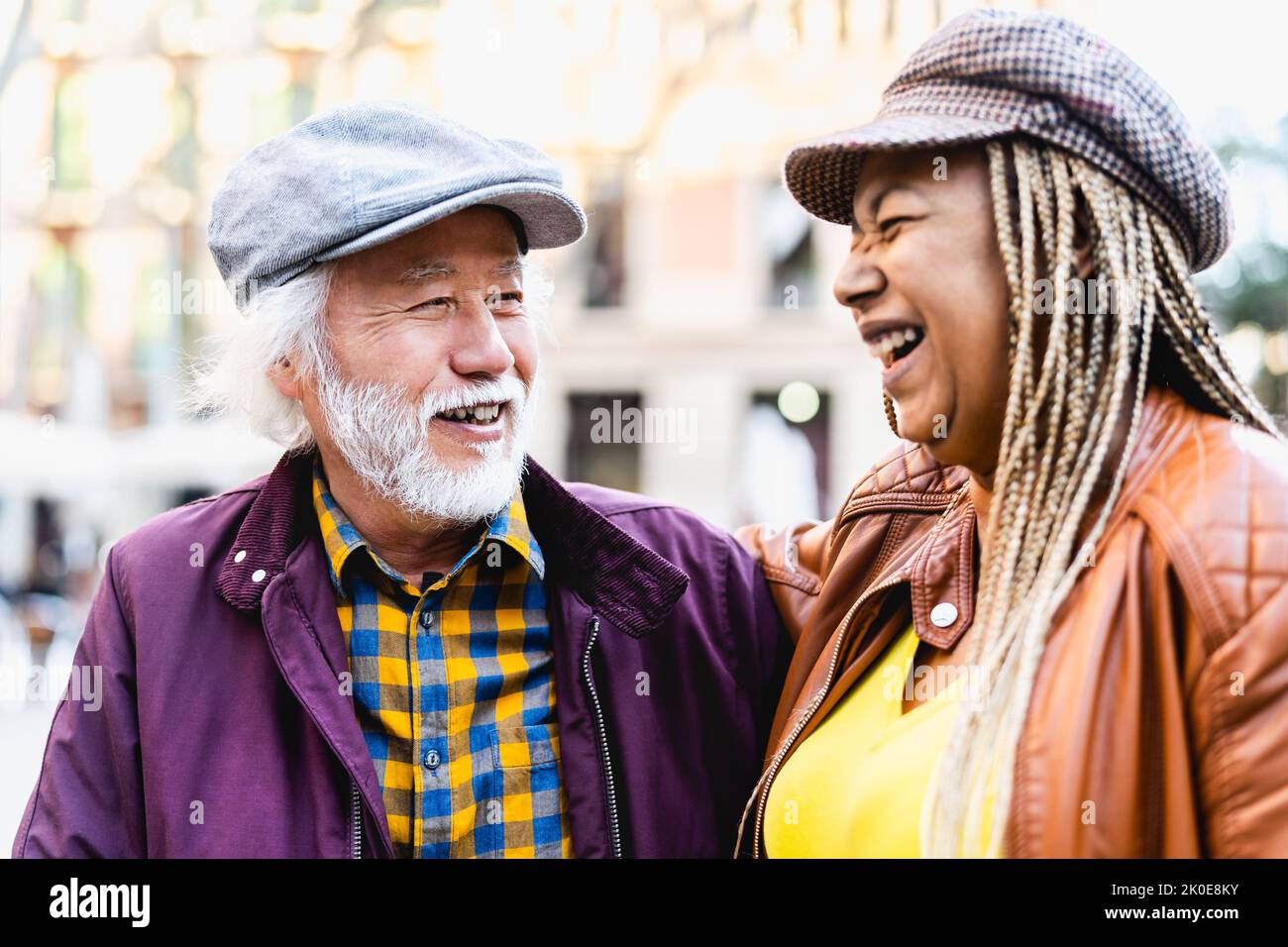 Happy multiracial senior couple having fun in city - Elderly people and love relationship concept Stock Photo