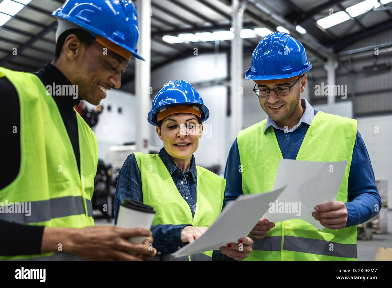 Team of multiracial engineers working in robotic factory - Tech industry concept Stock Photo