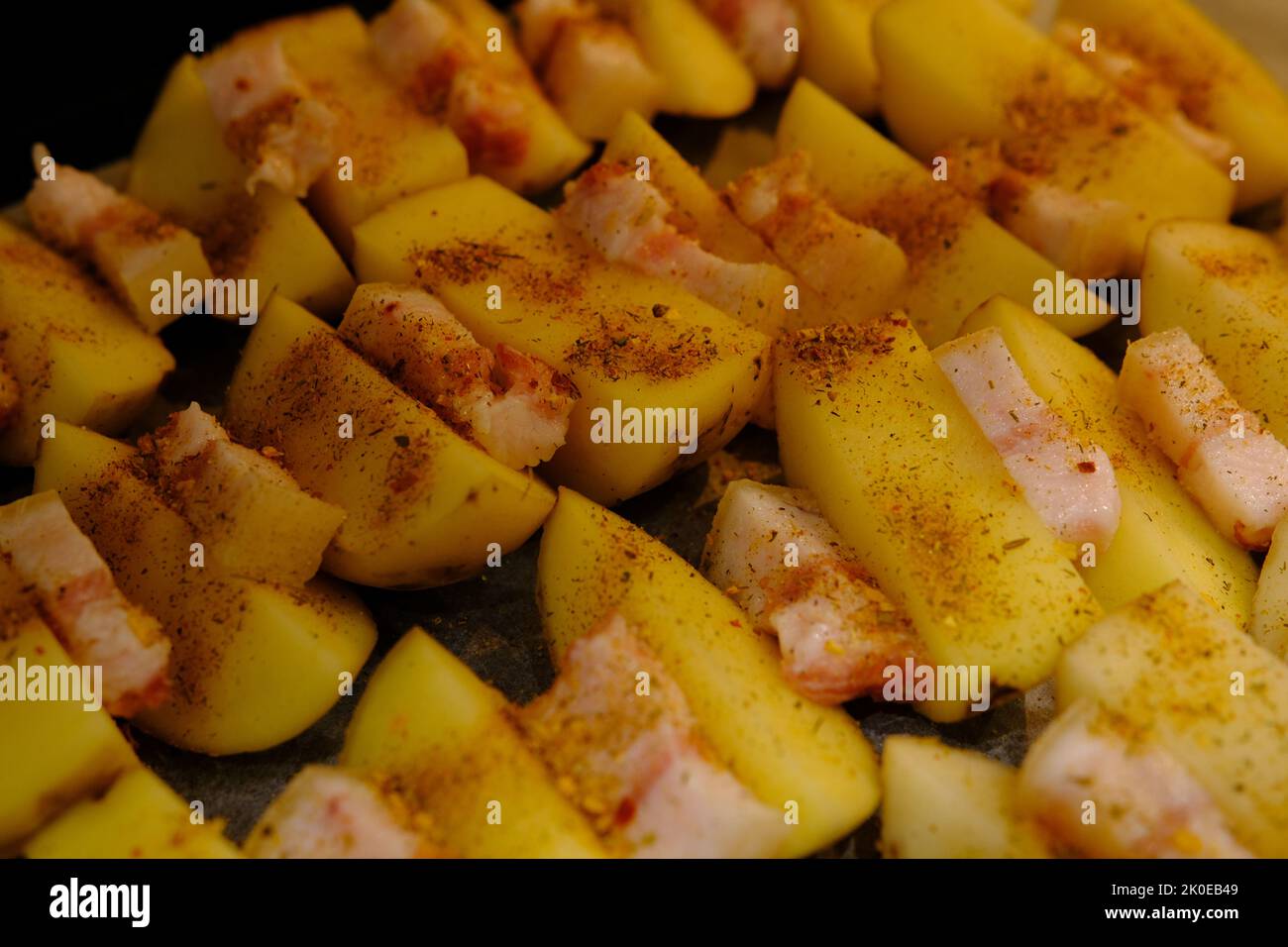 Delicious Potato Bratkartoffeln With Bacon close up in the plate on ready to bake. Stock Photo