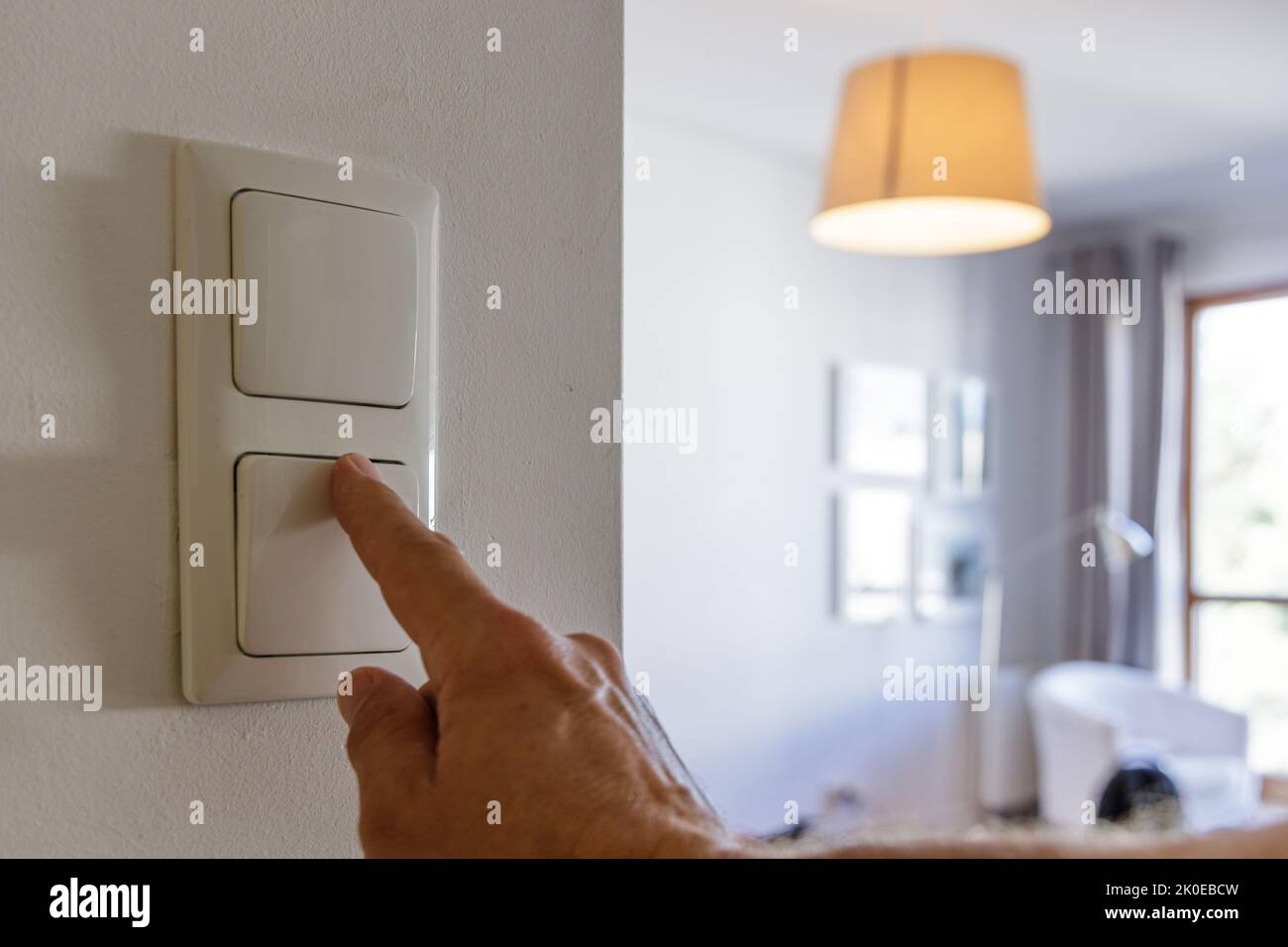 Saving energy at home, turning off the light Stock Photo