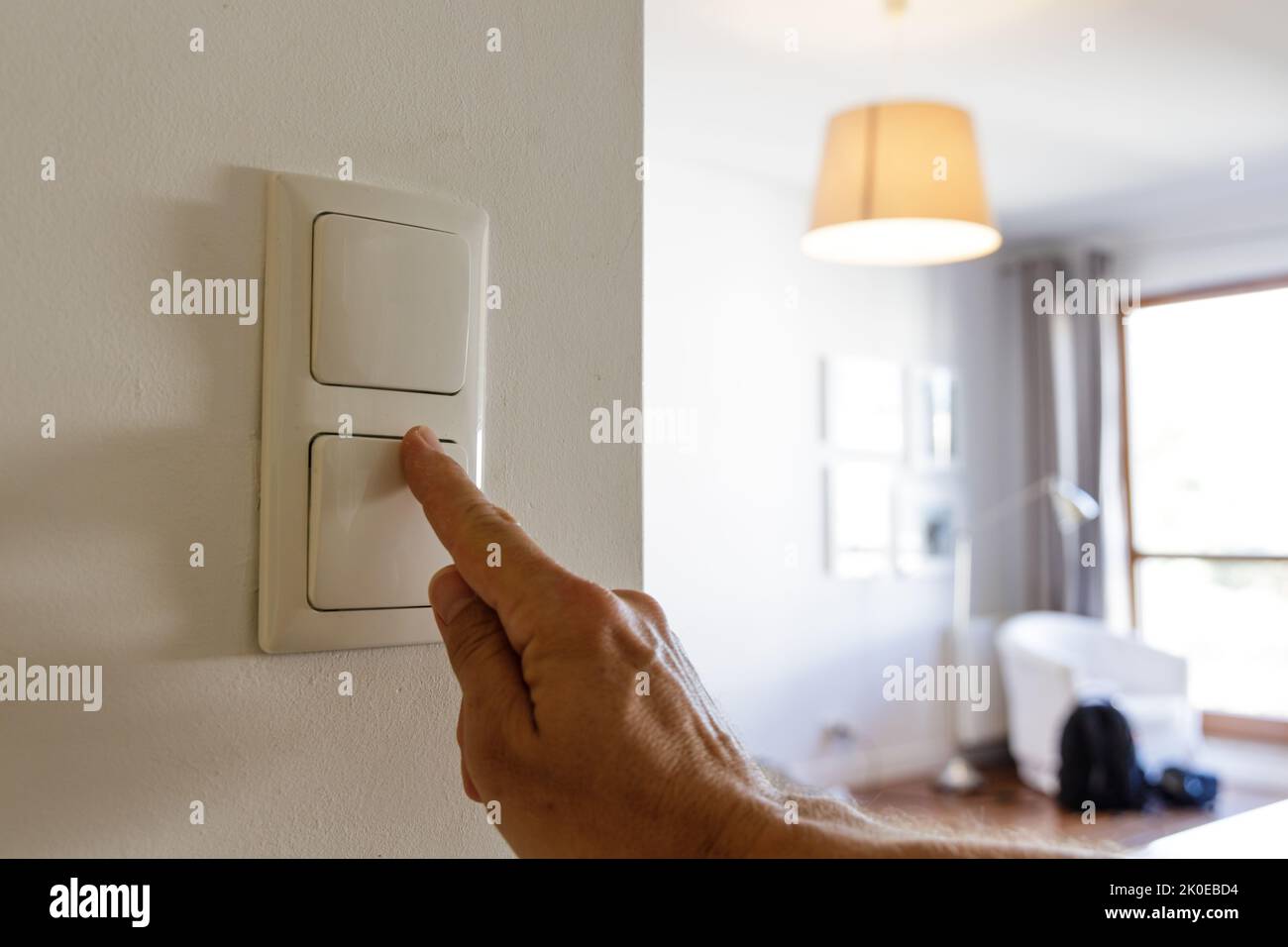 Saving energy at home, turning off the light Stock Photo
