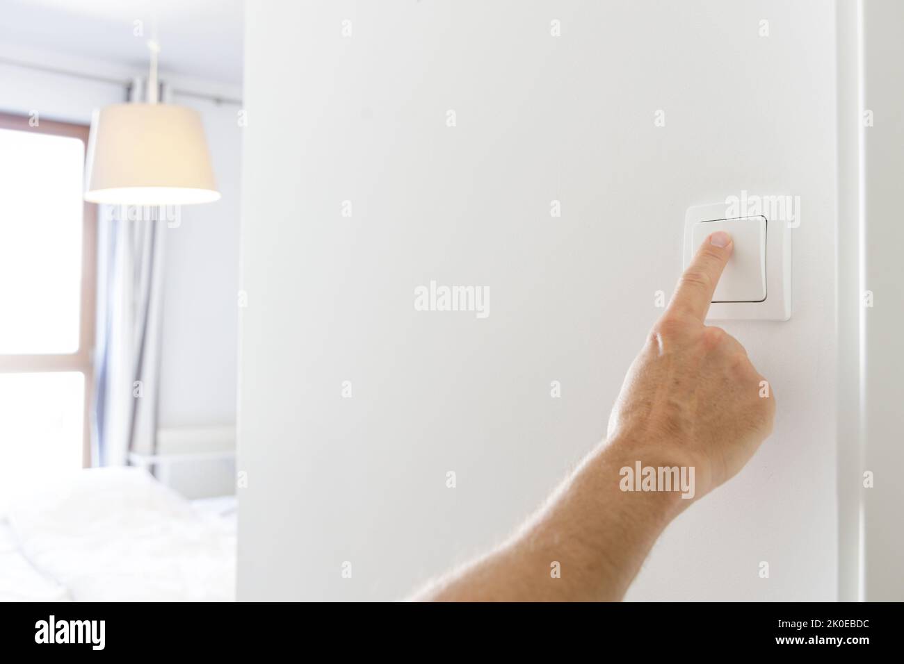 Saving energy at home, turning off the light Stock Photo Alamy