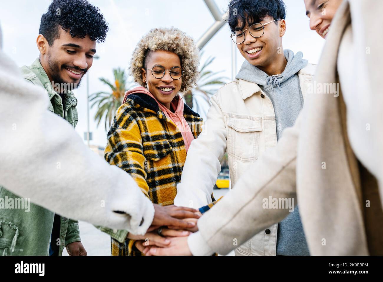 Group of multiracial friends stacking hands outdoor Stock Photo
