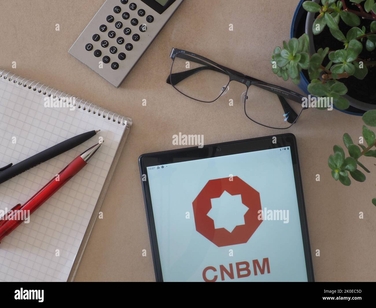 In this photo illustration, CNBM (China National Building Material Group) logo seen displayed on a tablet Stock Photo