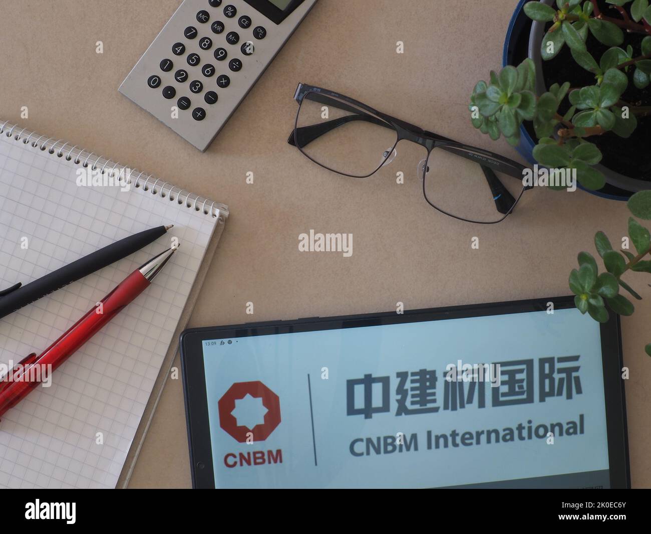 In this photo illustration, CNBM (China National Building Material Group) logo seen displayed on a tablet Stock Photo