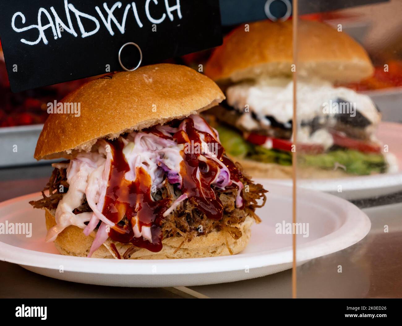 close up of two pulled pork sandwiches with sauces Stock Photo