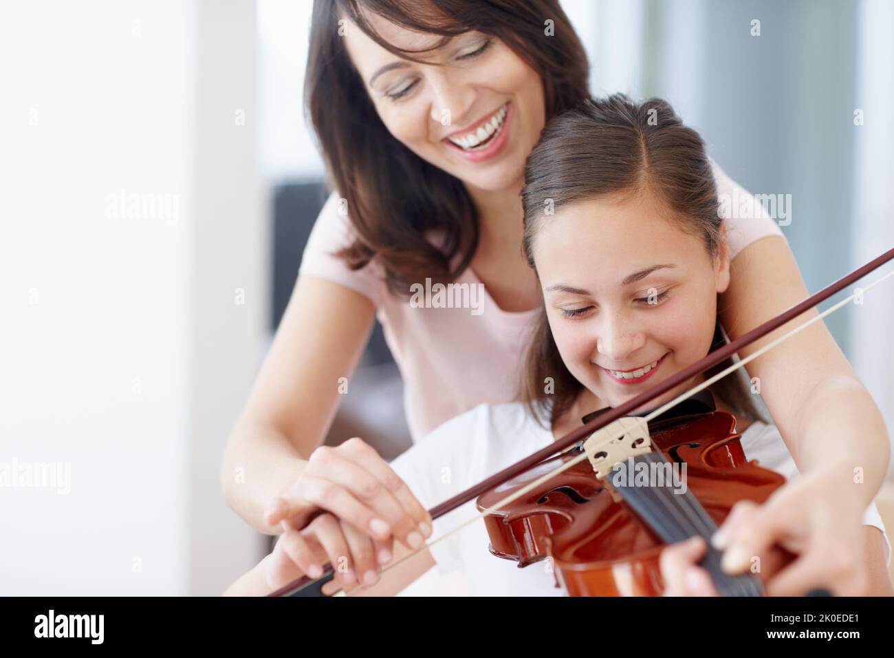 Making sweet melody together - Bonding. A mother helping her daughter practice the violin - Copyspace. Stock Photo