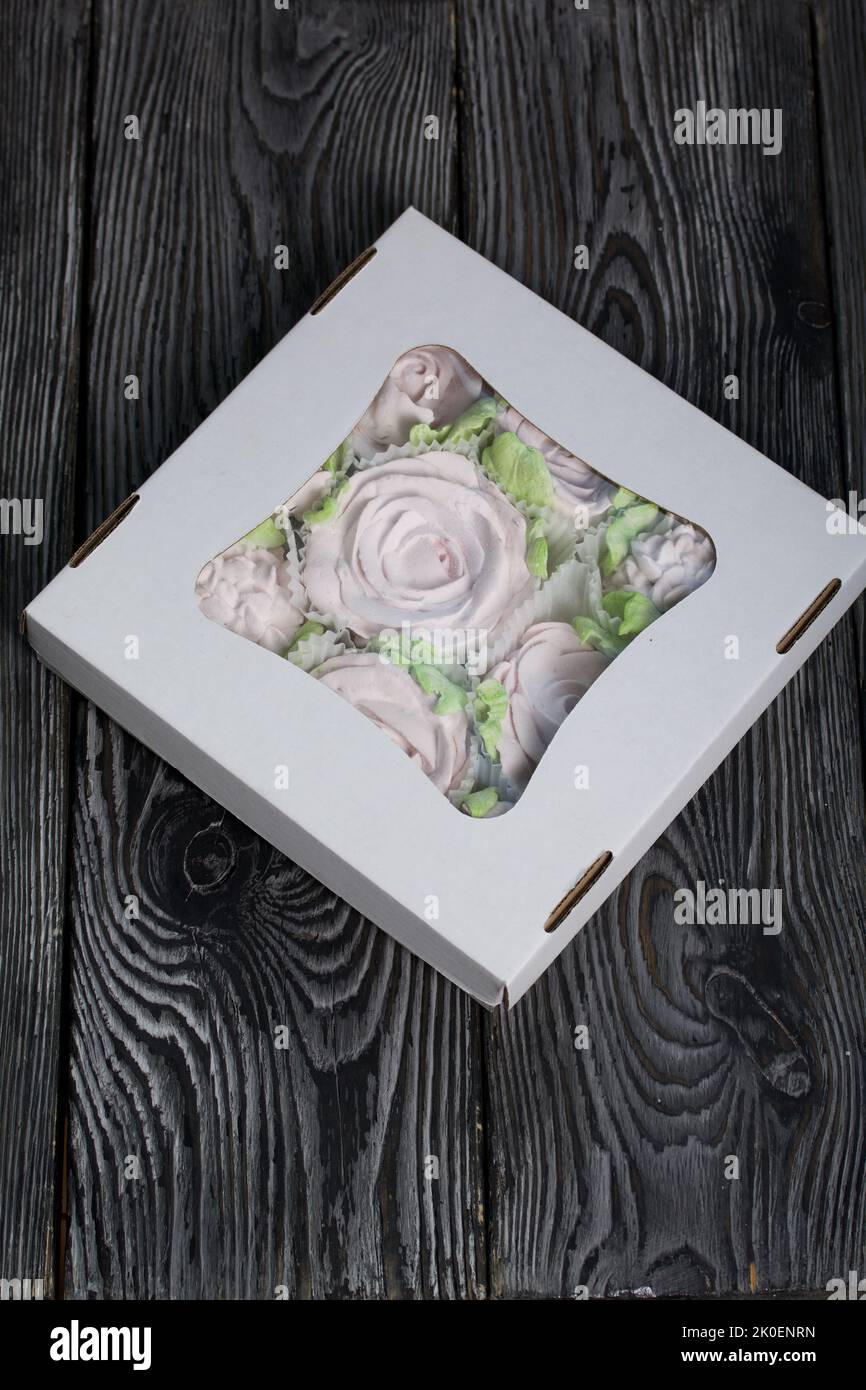 Zephyr flowers. Zephyr in a cardboard box. On pine boards. Stock Photo
