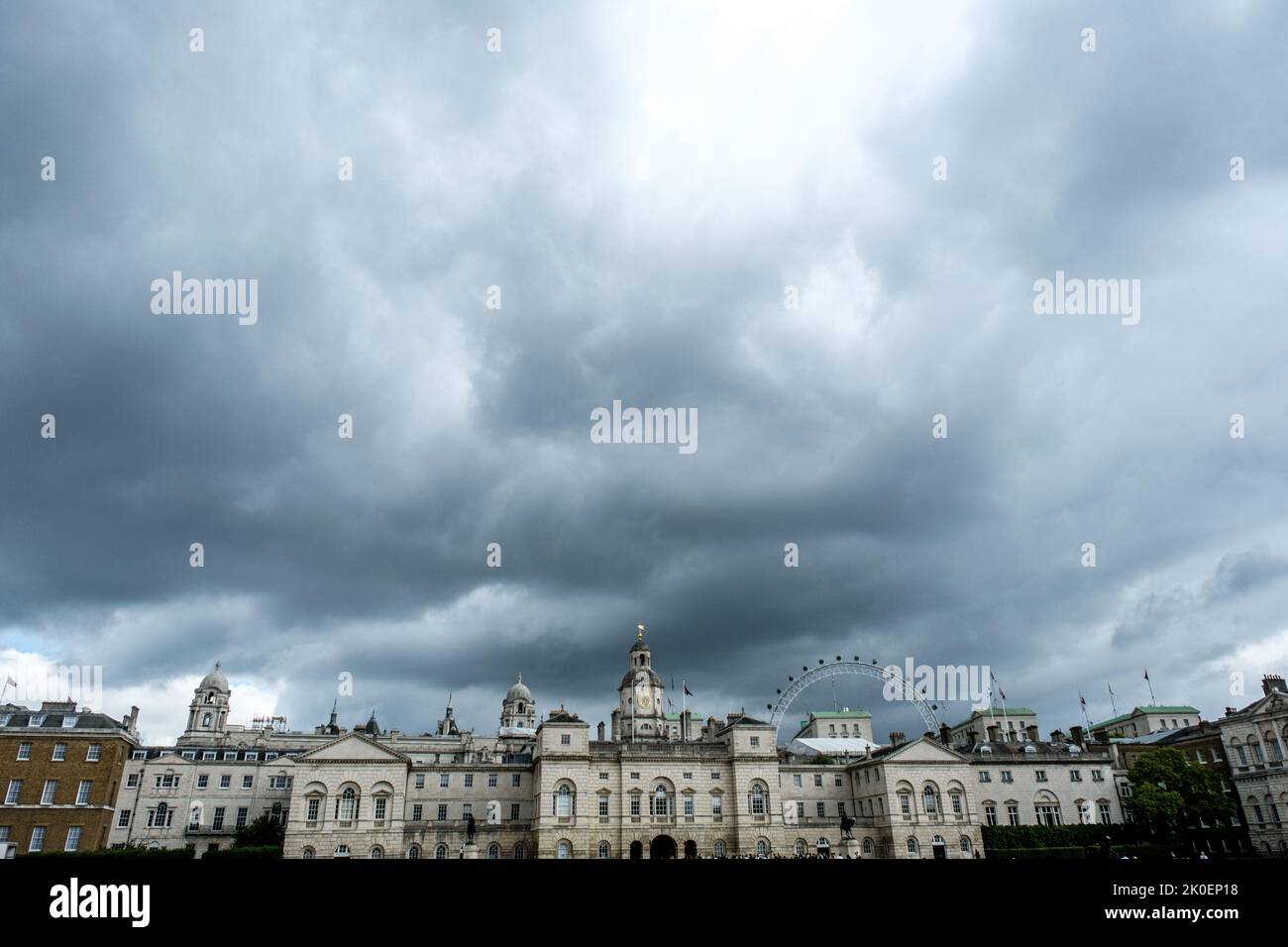 City of Westminster London, UK, September 10 2022, Horse Guards Building Exteriors Under Grey Storm Clouds With People Walking On Parade Ground Stock Photo